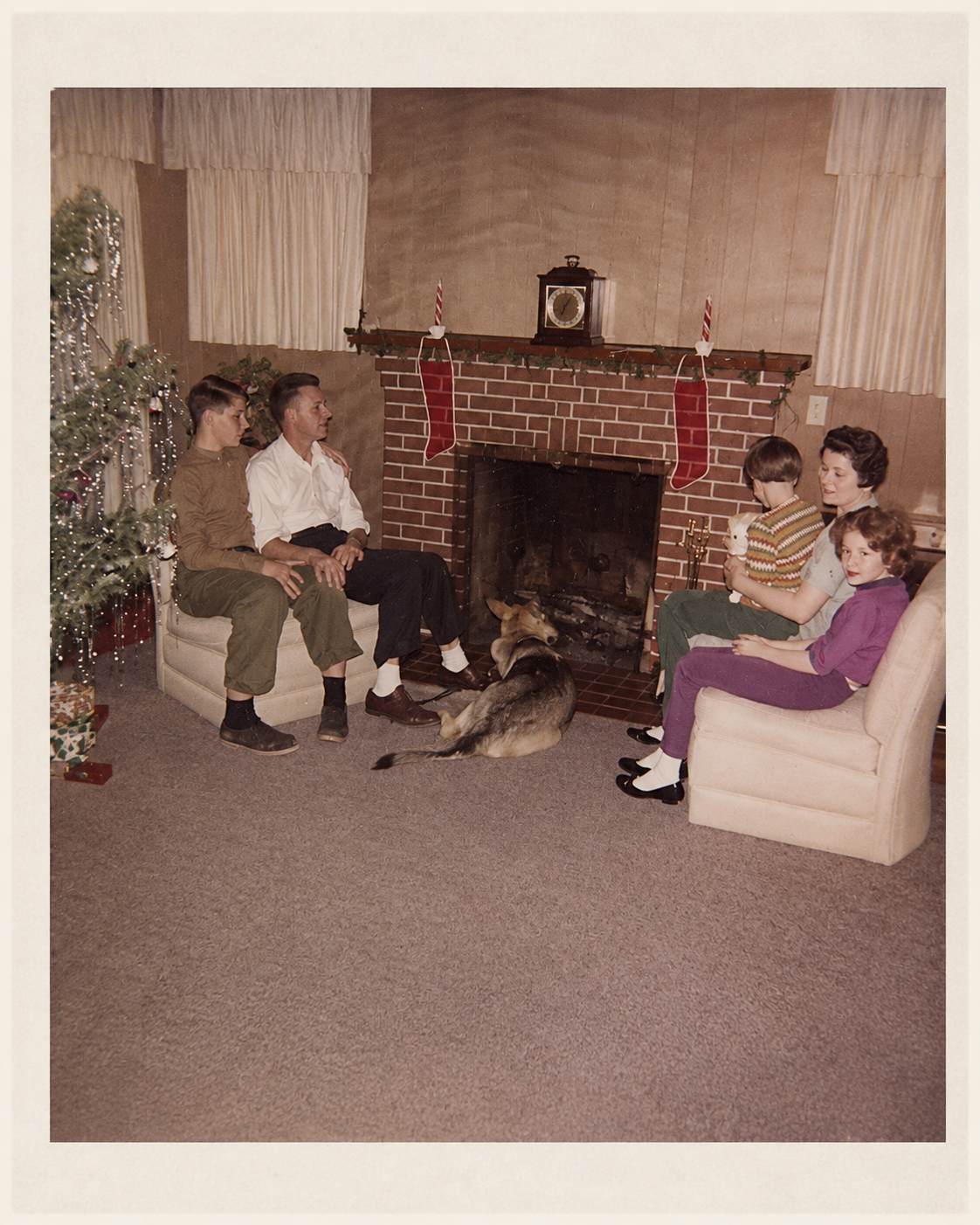 Christmas 1961 family gathering with John, Mario, Gary the Seeing Eye dog, Jane holding Mary, and Rita